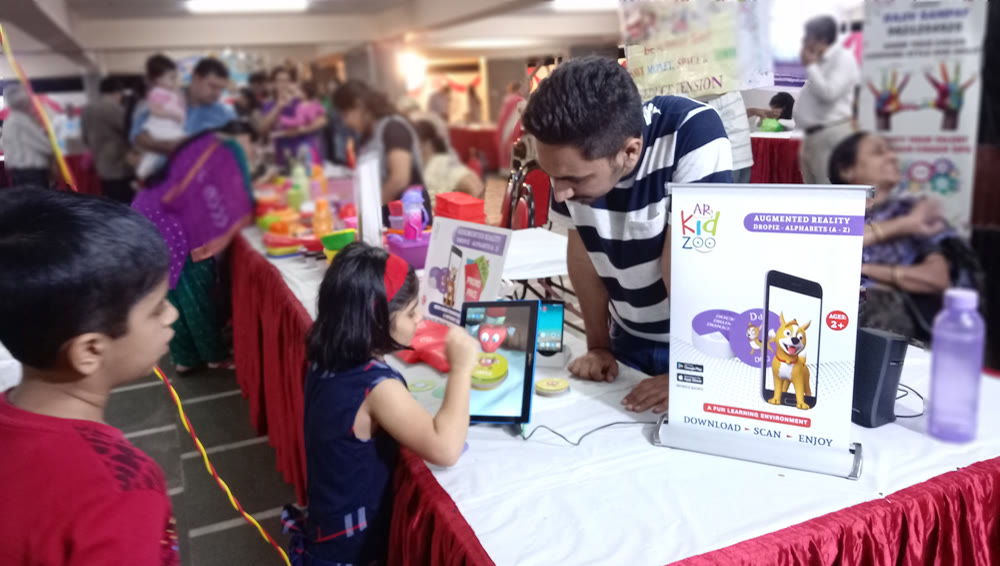 A live Dropiz AR demo with children at an early ARKidzoo expo stall