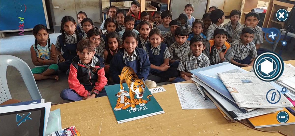 A 3D tiger appearing above a TIGER flashcard with children watching